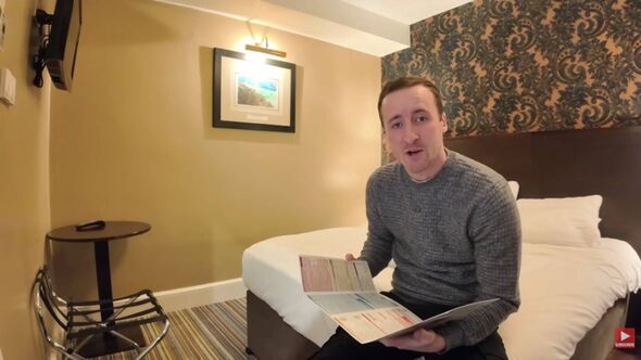 A man holding a wetherspoons menu