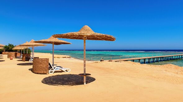 Idyllic sandy beach with sun umbrelas, Red Sea