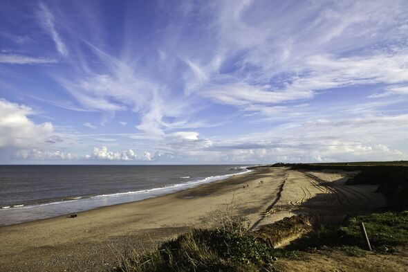 happisburgh beach with blue cloudy sky