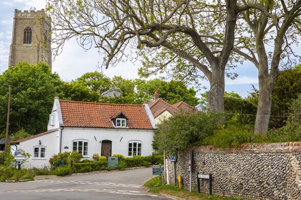 happisburgh village with white cottage and church in background