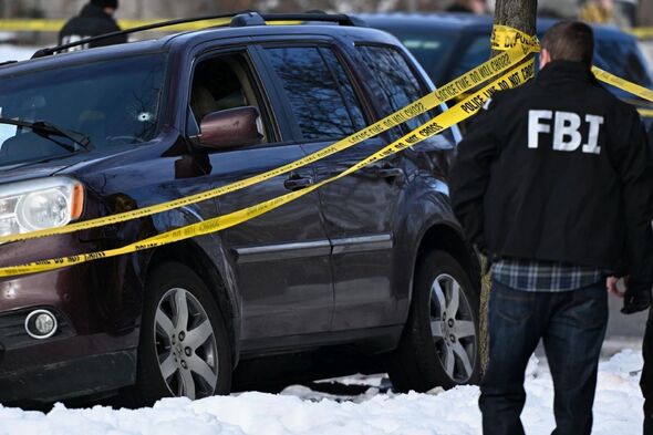 Bullet holes can be seen in the windshield of an SUV