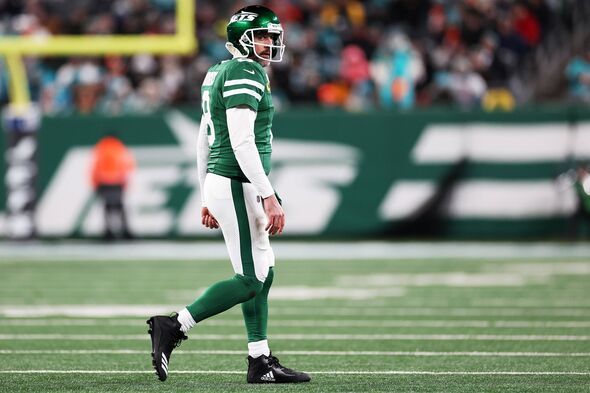 Aaron Rodgers #8 of the New York Jets walks off the field after an incompletion during the third quarter against the Miami Dolph