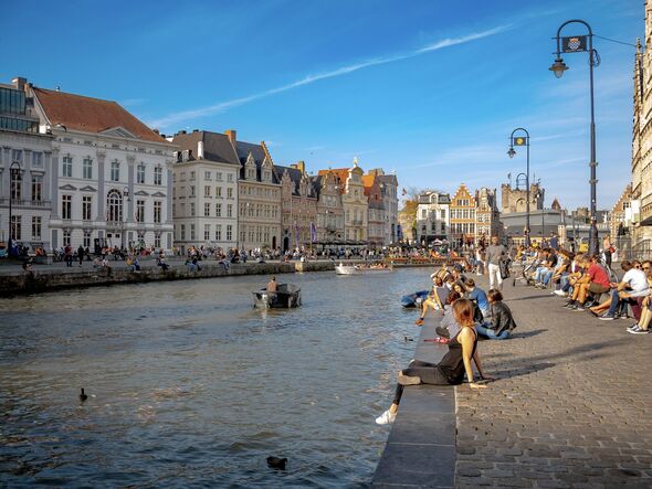 Tourists Relax by Ghent Leie River Canal in Belgium