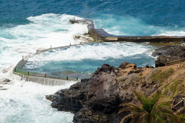 View of natural outdoor swimming pool in resort town of Los Gigantes (