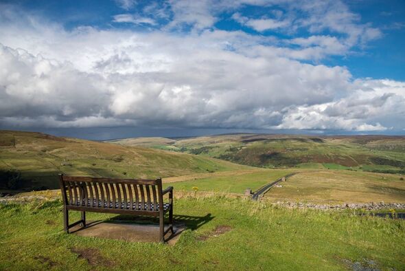 Pennine landscape around Muker as seen from the Buttertubs Pass on a September day. The bench situated beside the millenium cair