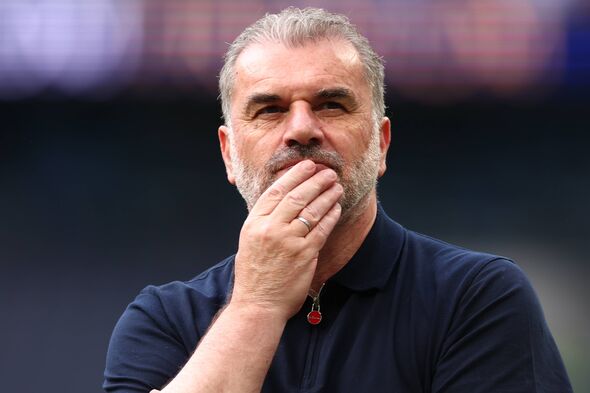Ange Postecoglou stands with his hand on his chin