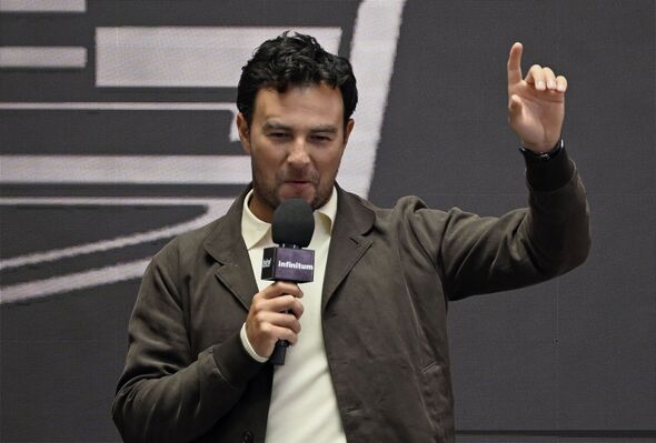 Sergio Perez in front of the Cadillac logo