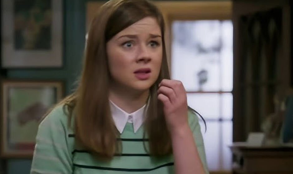 A girl in a striped jumper looks anxious