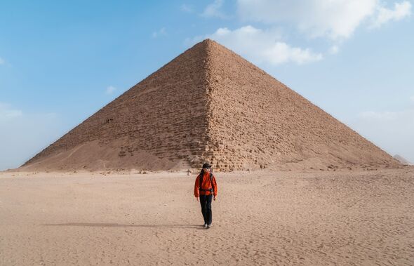 Traveler Walking Toward the Red Pyramid in Egypt