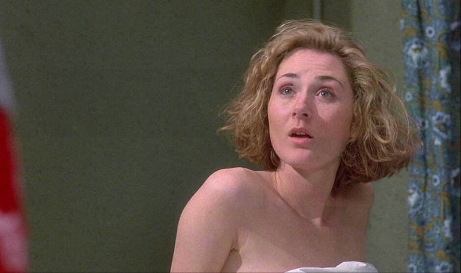 A woman with bare shoulders look surprised