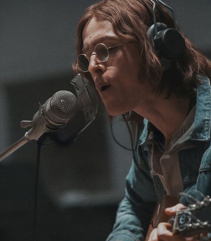 Close up of Harris Dickinson as John Lennon