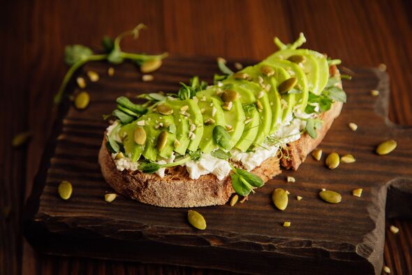 toast of country bread with pea sprouts, cream cheese and avocado with pumpkin seeds