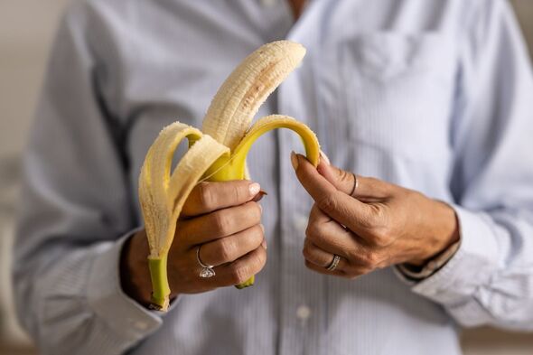 A person peeling a banana