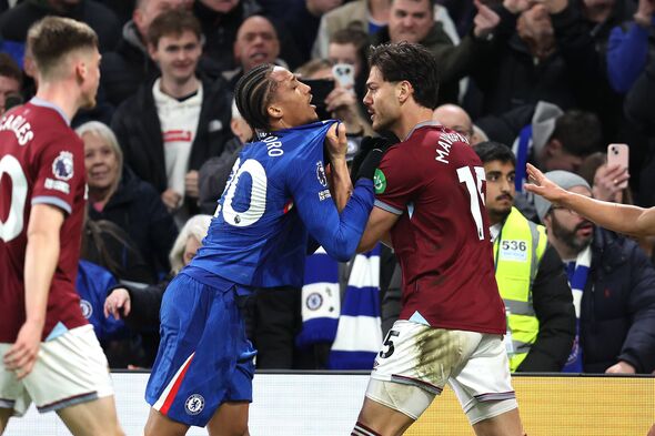 LONDON, ENGLAND - JANUARY 31: Konstantinos Mavropanos of West Ham United grabs the shirt of Joao Pedro of Chelsea as things get
