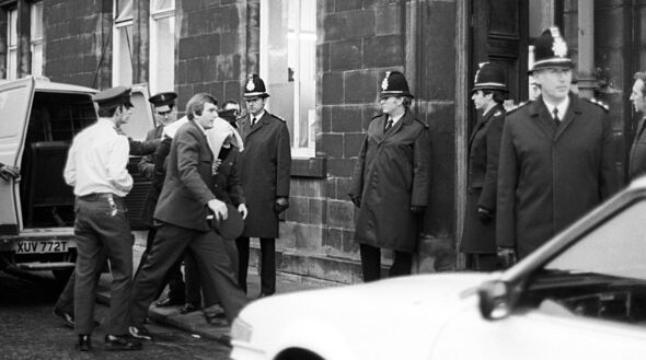 Police officers with Peter Sutcliffe under the blanket