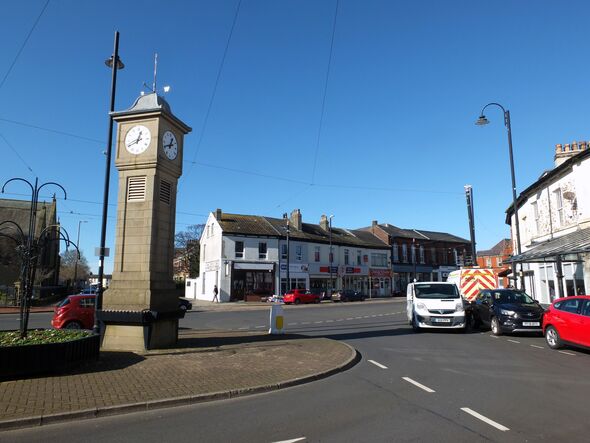 the rowntree clock in albert square fleetwood lancashire, surrounded by shops and traffic
