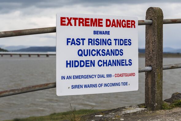 A warning side by the waterside at Arnside promenade. (Photo by: Jason Wells/Loop Images/Universal Images Group via Getty Images