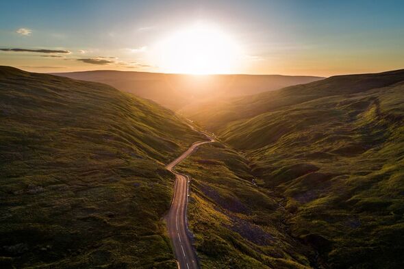 Aerial view of sunrise over Buttertubs pas in Yorkshire Dales national park.
