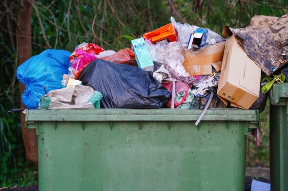 Overflowing garbage bin filled with mixed waste