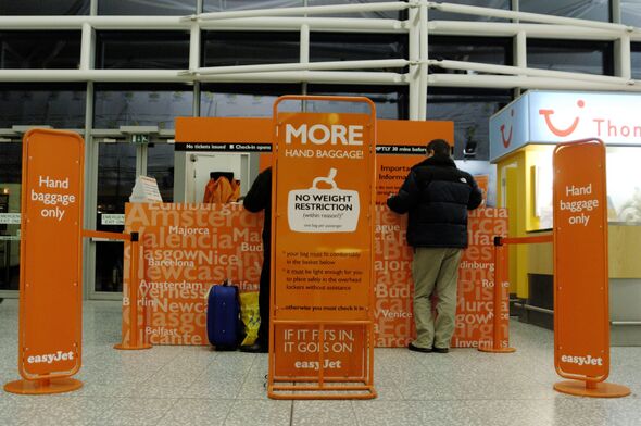 Man at easyJet carry-on baggage only check-in desks