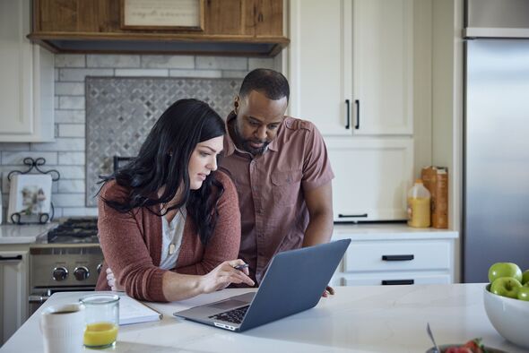 Couple working out finances using a laptop