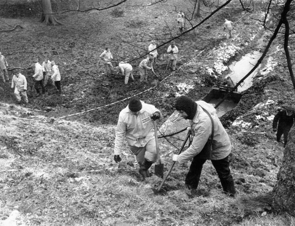 Police use metal detectors in a field in Bingley, near to the home of Peter Sutcliffe