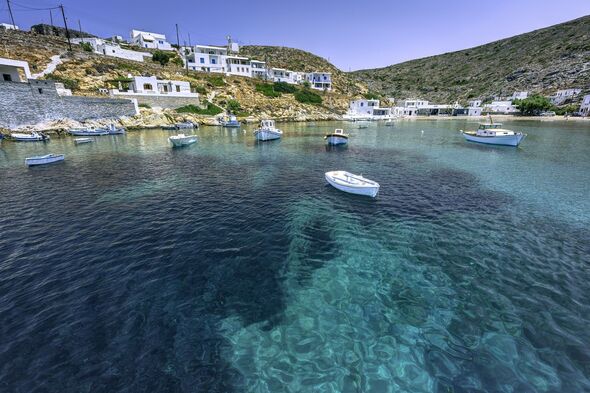 Picturesque small village of Heronissos, with fishing boats and transparent waters, in Sifnos island, Greece