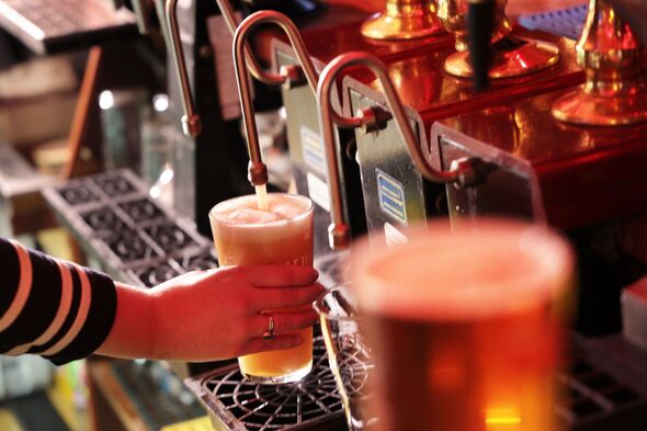 Pint of draught beer being poured