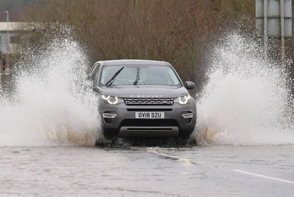 A vehicle is driven through a flooded road between Quorn and Mountsorrel in Leicestershire. Parts of the UK look set to be soake