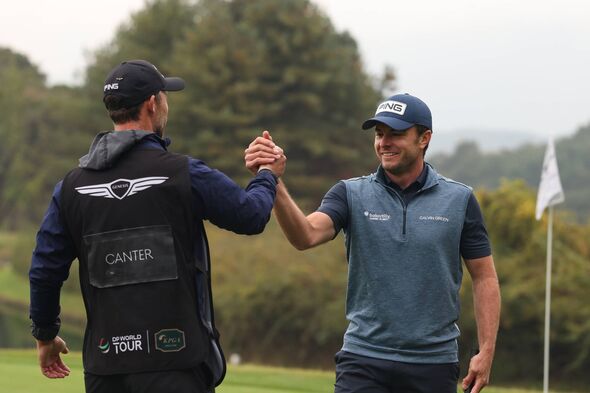 Laurie Canter celebrates with his caddie on-course