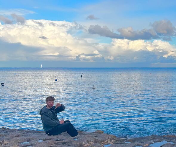 Picture of man sitting on a rocky beach