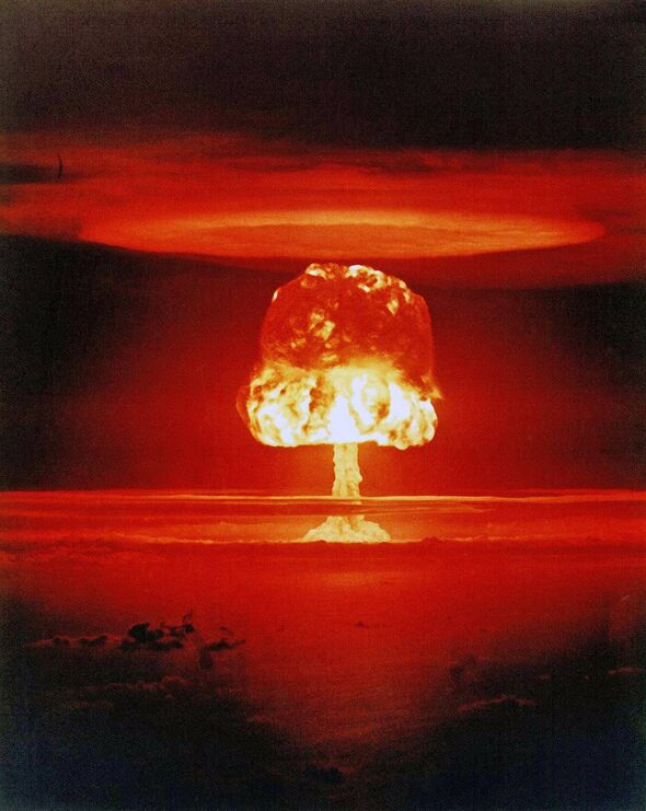 A nuclear explosion depicted in a dramatic, fiery red and yellow hue, showcasing the intense and destructive power of a nuclear
