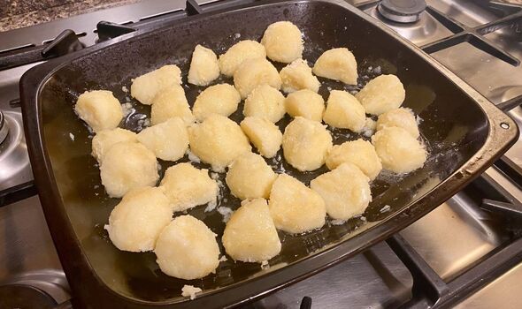 Potatoes on roasting tray before being put in oven