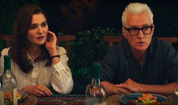 A man and a woman sitting at outdoor dinner table