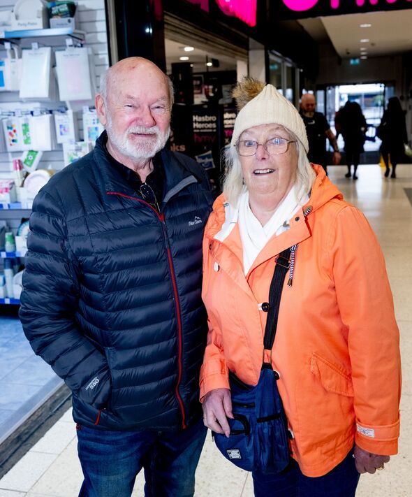 David and Sharon Fallows in front of shops