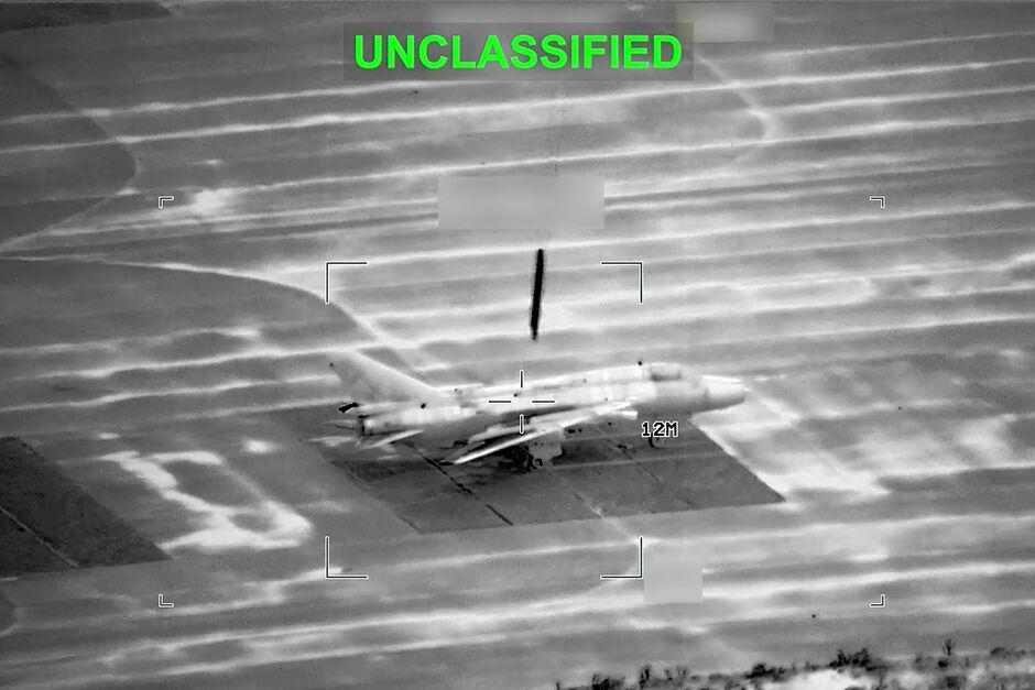 This partially redacted image from video provided by U.S. Central Command shows a military aircraft in Iran shortly before it was struck by a missile