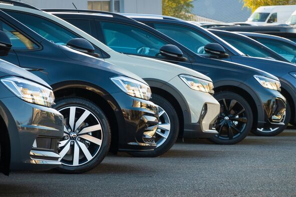A row of used VW cars parked at a public car dealership in Hamburg, Germany