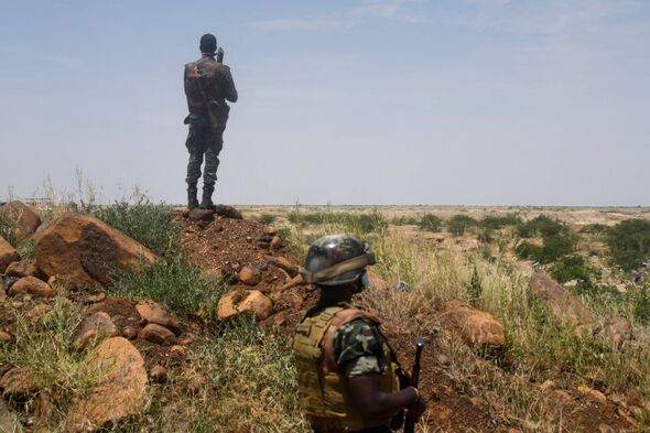 Niger's soldiers stand guard and patrol, on September 10, 2021 near the construction site of the first dam that the country builds on the Niger river