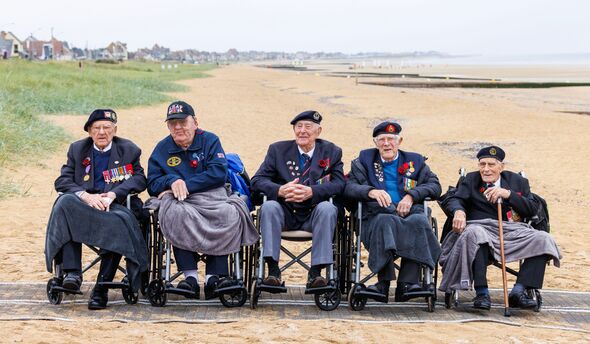 John and other D-Day veterans in a line on beach