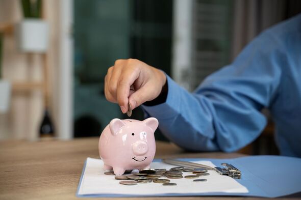 A person putting money into a piggy bank
