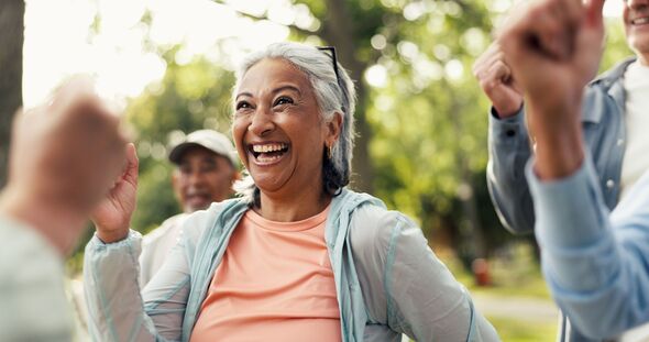 Cardio, exercise group and funny with old woman in garden for health or wellness with friends. Fitness class, laughing and training with happy senior