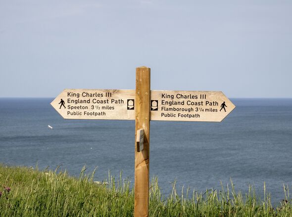 A sign for the England Coast Path at Bempton Cliffs in Yorkshire, UK.