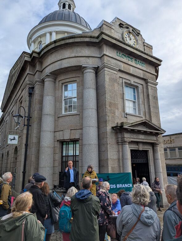 Andrew George on the steps of Lloyds' former building in Penzance