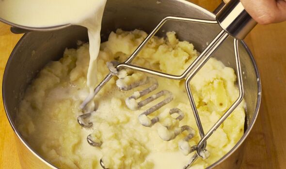Picture of someone adding milk to mashed potatoes