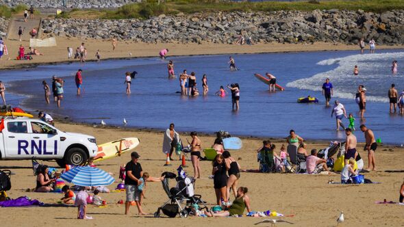 Porthcawl, Bridgend, Wales - Aug 15b 2024: Coney Beach in Porthcawl on a busy summer's day with the weather warm enough for swim