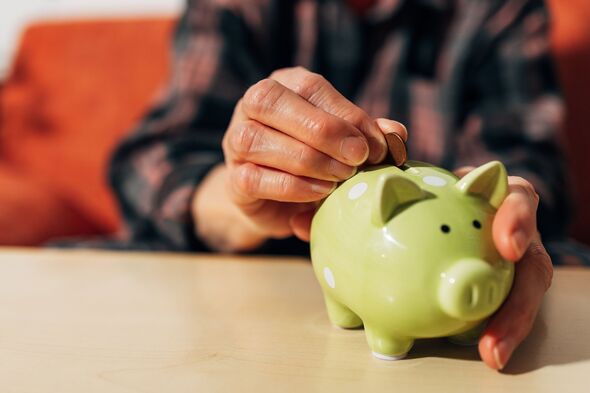 Senior adult saving money in a green piggy bank