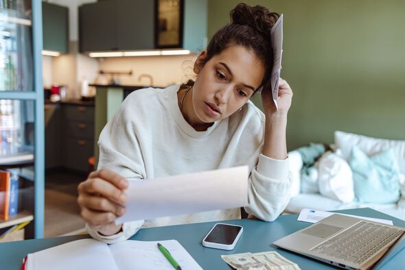 Woman looking stressed about bills