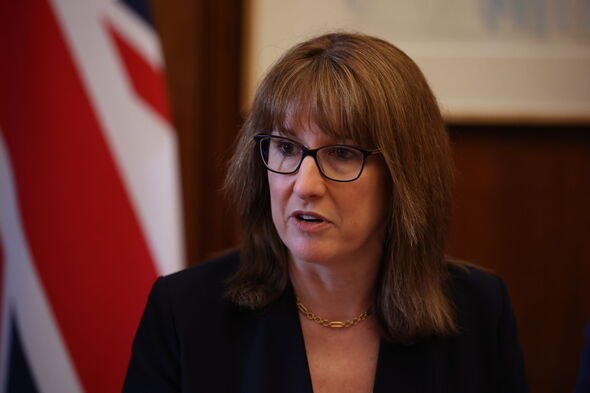 Rachel Reeves sits at a table wearing glasses