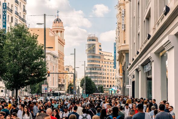 Crowds of people on Gran Via Avenue, Madrid, Spain