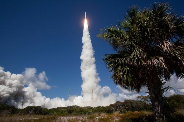 An image depicting a rocket launch, with a trail of smoke and fire ascending into the sky, set against a backdrop of a blue sky
